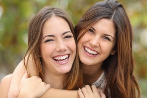 Two Women Friends Laughing With A Perfect White Teeth